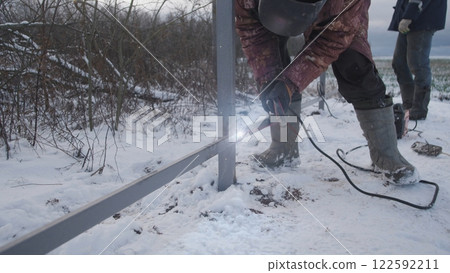 Professional worker performs welding work Professional worker performs welding work 122592211