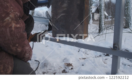 Professional worker performs welding work 122592212