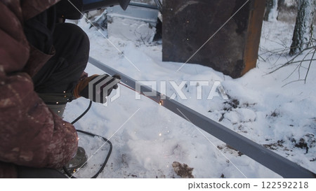 Professional worker performs welding work 122592218