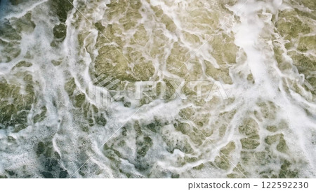 An Aerial View of the Turbulent and Chaotic Ocean Waves from Above a Scenic Coastline 122592230