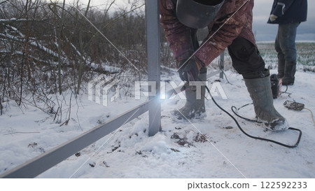 Professional worker performs welding work 122592233