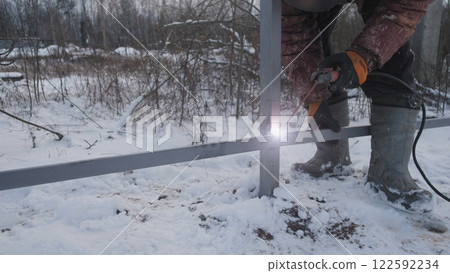 Professional worker performs welding work 122592234