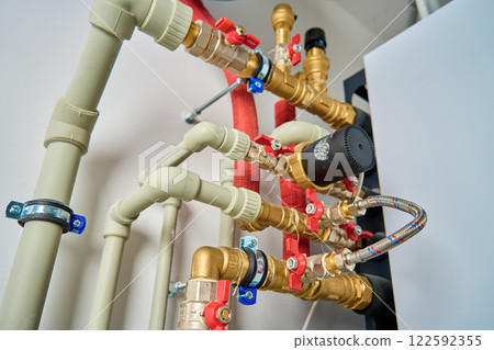 Heating system with pipes, valves, and brass fittings 122592355