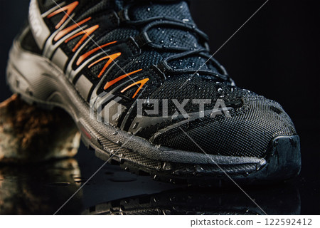 Hiking Shoe on Stone with Water Droplets Hiking Shoe on Stone with Water Droplets 122592412
