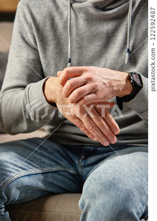 Man scratching itchy hand due to skin irritation 122592487