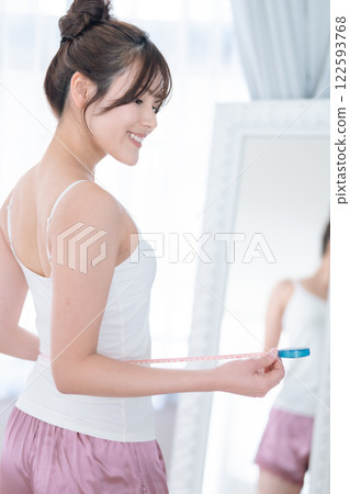 A young woman smiling after a successful diet A young woman smiling after a successful diet 122593768