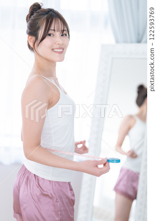 A young woman smiling after a successful diet A young woman smiling after a successful diet 122593769