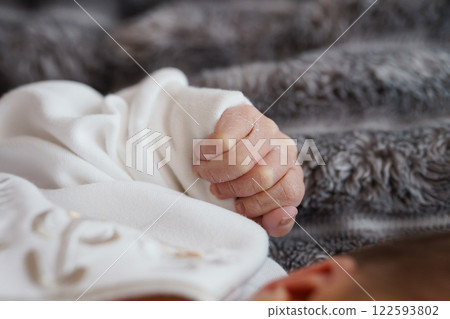 Tender Baby Hand Grasping Soft Fabric with Cozy Background Tender Baby Hand Grasping Soft Fabric with Cozy Background 122593802