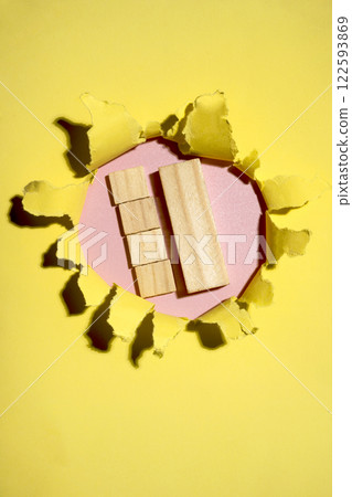 Wooden cubes on the hole of ripped paper. Mockup or Copy space. Template. Presentation or advertising. Concept of message or communication 122593869