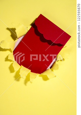 Red envelope from the hole of ripped paper. Mockup or Copy space. Template. Greetings or invitation. Concept of message or communication 122593870