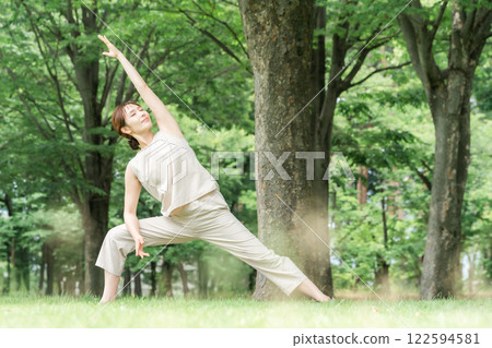 年輕的亞洲女性在公園做瑜珈、瑜珈、皮拉提斯、在森林/公園伸展運動(三角姿勢) 年輕的亞洲女性在公園做瑜珈、瑜珈、皮拉提斯、在森林/公園伸展運動(三角姿勢) 122594581