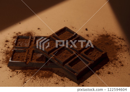 A bar of chocolate on a brown background A bar of chocolate on a brown background 122594604