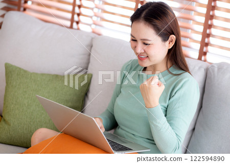Young asian business woman working with laptop sitting on sofa in home office. 122594890