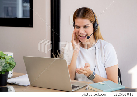 Professional young business woman working and meeting online in modern home office. Professional young business woman working and meeting online in modern home office. 122595015