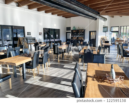 Restaurant, tasting room with natural olive wood furniture. Furniture and interior. Agriculture and winemaking of Liguria, Italy. Restaurant, tasting room with natural olive wood furniture. Furniture and interior. Agriculture and winemaking of Liguria, Italy. 122595138