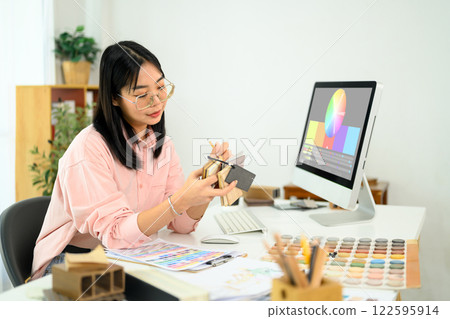 Female designer selecting colors and materials for an interior project 122595914