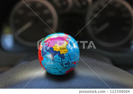Defocused Dial Car Dashboard And Colored Globe Model On Foreground. Time to vacation theme stock image 122598084