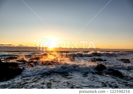 A sunrise scene at Kamiiso with raging waves and rocks burning like flames 122598258