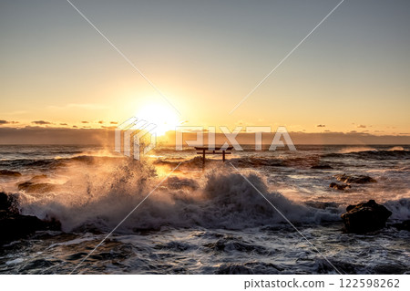 A sunrise scene at Kamiiso with raging waves and rocks burning like flames A sunrise scene at Kamiiso with raging waves and rocks burning like flames 122598262
