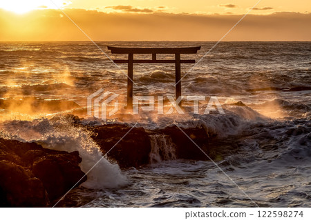 A sunrise scene at Kamiiso with raging waves and rocks burning like flames 122598274