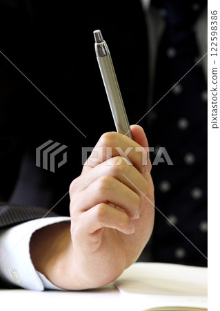 Close-up of a man holding a pen Close-up of a man holding a pen 122598386