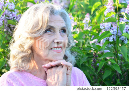 Portrait of a beautiful elderly woman in the park Portrait of a beautiful elderly woman in the park 122598457