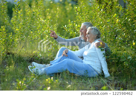 Portrait of senior couple sitting on the grass in the park 122598462