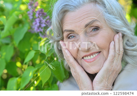 Portrait of a beautiful elderly woman in the park Portrait of a beautiful elderly woman in the park 122598474