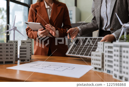 Asian business people using tablet for working technology and business, Renewable energy-based green businesses and global warming. Reduce CO2 emission. Asian business people using tablet for working technology and business, Renewable energy-based green businesses and global warming. Reduce CO2 emission. 122598868