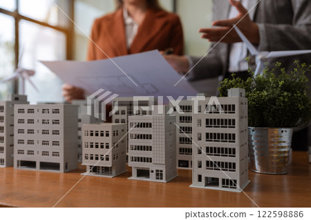 House model with agent asking costumer for contract to buy, get insurance or loan real estate or property. House model with agent asking costumer for contract to buy, get insurance or loan real estate or property. 122598886