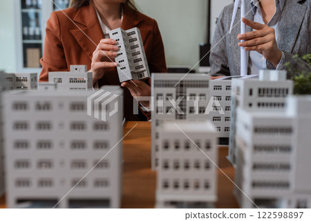House model with agent asking costumer for contract to buy, get insurance or loan real estate or property. House model with agent asking costumer for contract to buy, get insurance or loan real estate or property. 122598897