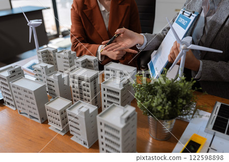 House model with agent asking costumer for contract to buy, get insurance or loan real estate or property. House model with agent asking costumer for contract to buy, get insurance or loan real estate or property. 122598898