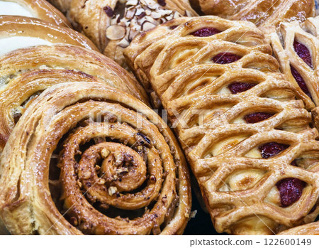 Freshly baked pastries displayed in a bakery showcasing a variety of textures and flavors 122600149