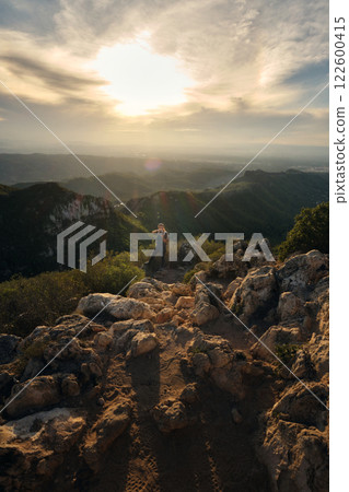 Woman with a backpack on her back on top of a mountain 122600415