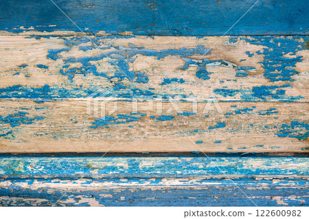 Blue paint peeling off the wooden wall 122600982