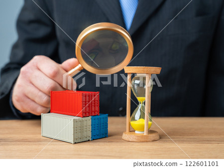 A man studies freight transportation terms. Acceleration of cargo customs clearance and eradication of corruption risks. Secure and efficient trade processes. A man studies freight transportation terms. Acceleration of cargo customs clearance and eradication of corruption risks. Secure and efficient trade processes. 122601101