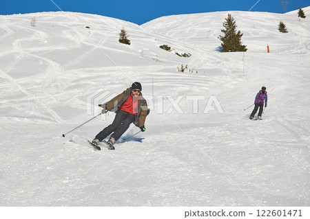 Skiing in the winter snowy slopes 122601471