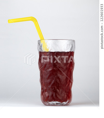A cold, refreshing berry drink is presented in a glass with a yellow straw 122601933