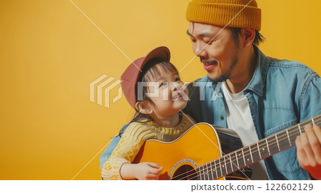 Father playing guitar with little boy with happiness smile  for learning music Father playing guitar with little boy with happiness smile  for learning music 122602129