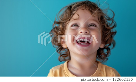 A little boy smile laughing happiness wearing yellow t shirt isolate color background A little boy smile laughing happiness wearing yellow t shirt isolate color background 122602130