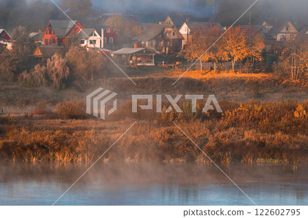 Autumn fog over river Daugava and houses of small town Kraslava in Latvia 122602795