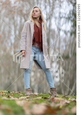 Young woman walking in park during autumn season Young woman walking in park during autumn season 122602995