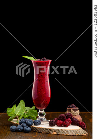 Glass of red currant berries fresh shake decorated with mint and blueberry isolated at white background. Glass of red currant berries fresh shake decorated with mint and blueberry isolated at white background. 122603962