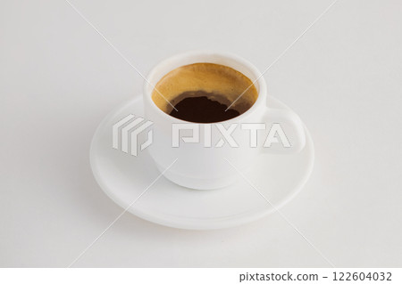 Closeup image of hot cup of espresso coffee isolated at white background. 122604032