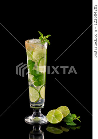 Closeup glass of fresh mojito cocktail with mint and lime isolated at black background. Closeup glass of fresh mojito cocktail with mint and lime isolated at black background. 122604205
