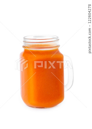 Closeup glass jar of carrot juice isolated at white background. Concept of healthy vegan food Closeup glass jar of carrot juice isolated at white background. Concept of healthy vegan food 122604278