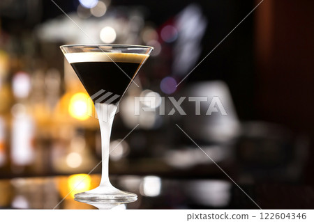 Glass of black russian cocktail at bar counter background. Glass of black russian cocktail at bar counter background. 122604346