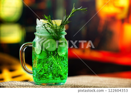 Closeup jar of cucumber and tarragon lemonade served at bar background. Closeup jar of cucumber and tarragon lemonade served at bar background. 122604353