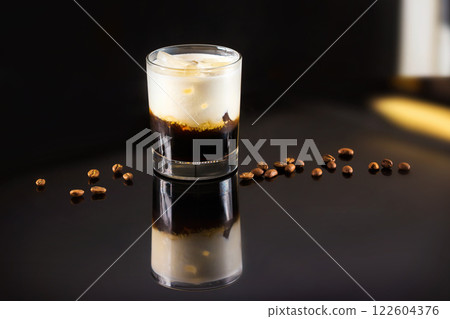 Closeup image of glass of black Russian cocktail and coffee beans at dark bar stand background. Closeup image of glass of black Russian cocktail and coffee beans at dark bar stand background. 122604376