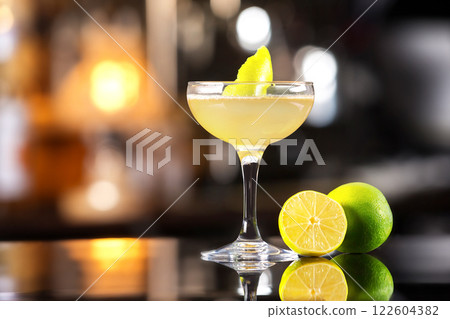 Closeup image of daiquiri cocktail decorated with lemon at bar counter background. Closeup image of daiquiri cocktail decorated with lemon at bar counter background. 122604382